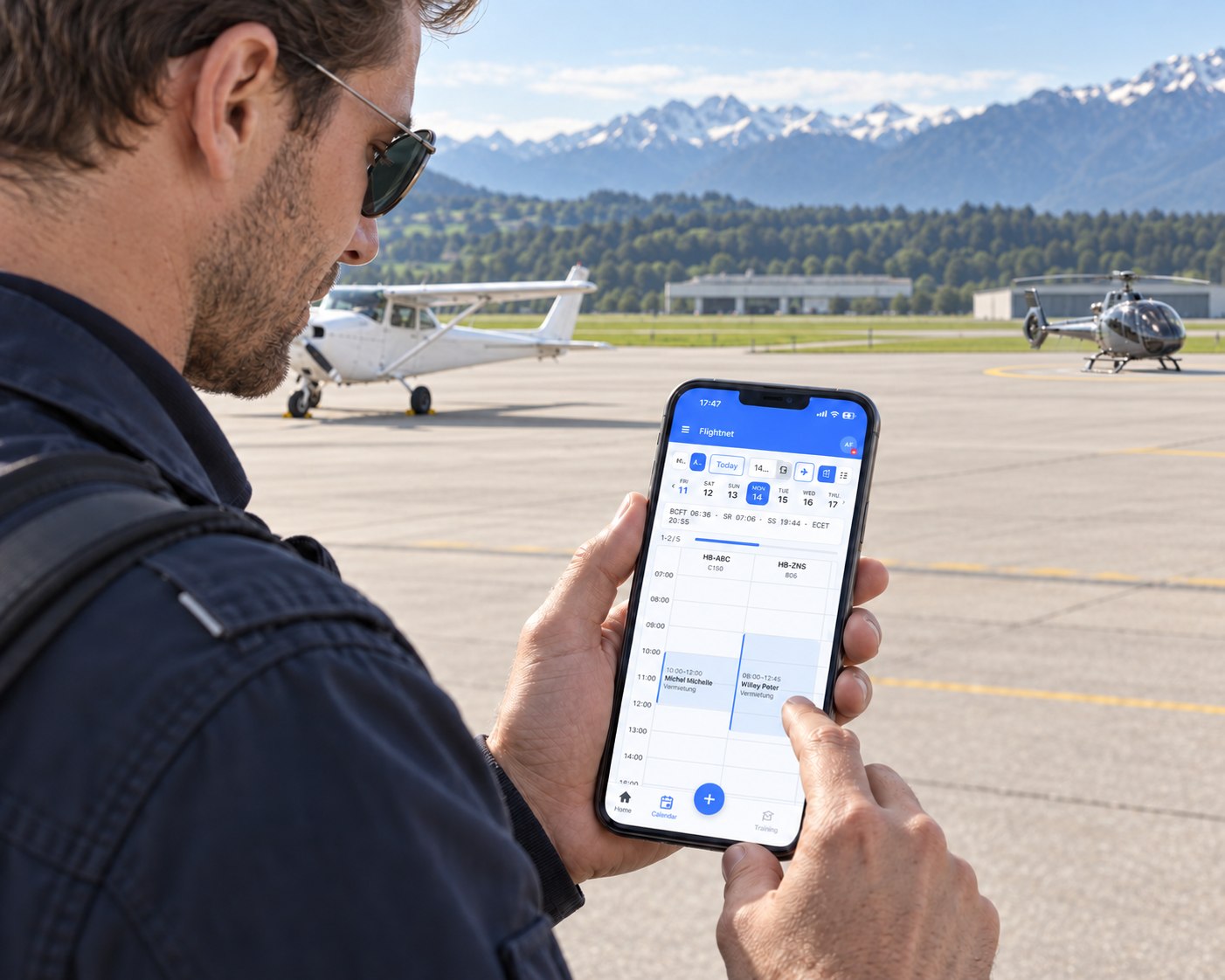 Pilot using the Flightnet mobile app on an airfield, with a light aircraft and helicopter in the background